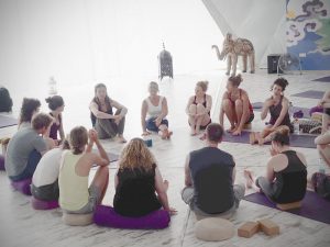 Carol Murphy teaching a Yin Yoga Teacher Training in the dome at Suryalila, Spain with students seated in a circle.