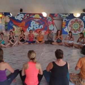 Carol Murphy teaching a large group of yoga students sitting in a circle during the 50-hour Yin Yoga Teacher Training at Suryalila Retreat Centre in Spain.