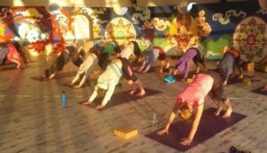Yin Yoga Teacher Training in Spain at Suryalila Retreat Centre with group practising Downward Dog in the Geodesic Dome
